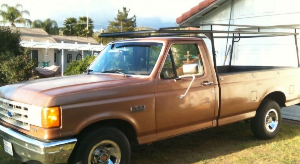 80 s model brown Ford F 150 with ladder racks similar to this vehicle
