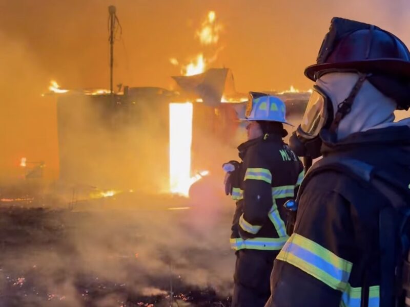 Marion County Fire Rescue firefighters survey the scene of a fire that destroyed a structure in Belleview.