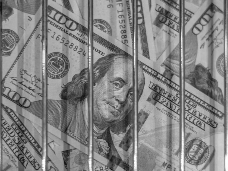 Money behind jail bars to illustrate civil restitution lien