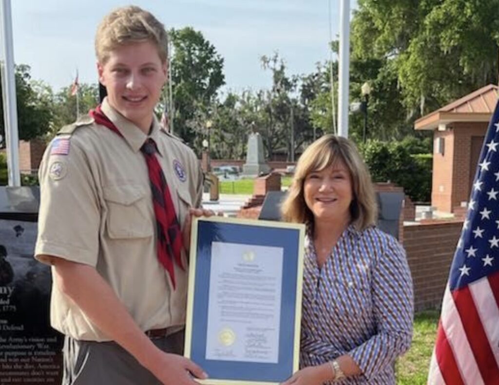 Nicholas Eggers receives a proclamation from Marion County Board of County Commissioners Chairwoman Kathy Bryant