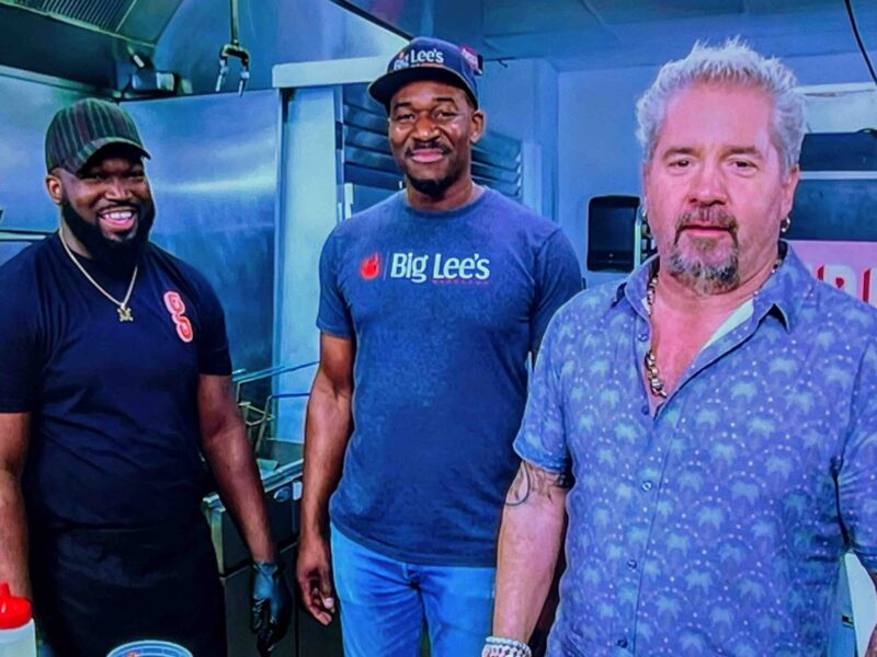 Widlyn Germain left , Rashad Jones center , and Guy Fieri right at Germain s restaurant in Gainesville