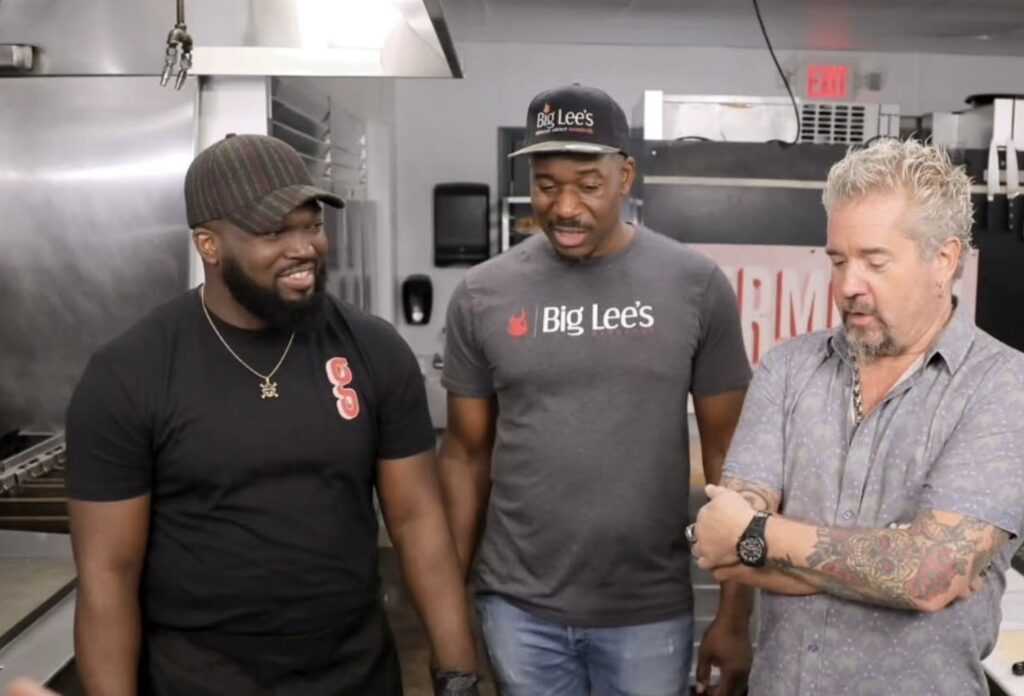 Widlyn Germain (left), Rashad Jones (middle), and Guy Fieri (right), during the taping of Diners, Drive-Ins, and Dives at Germain's in Gainesville.