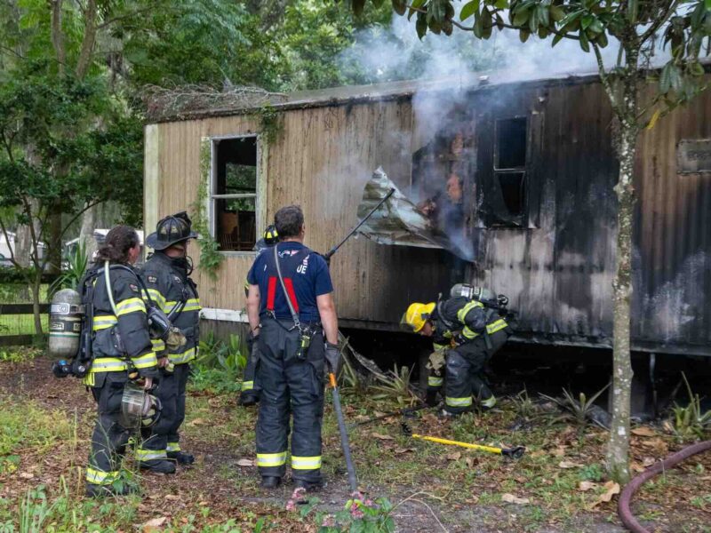 Firefighters working to break into mobile home in Citra