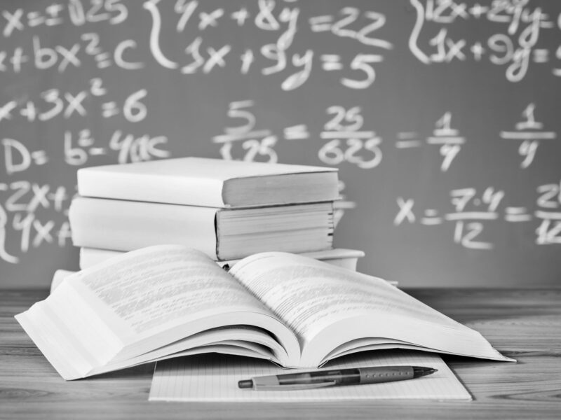 Textbook in front of a chalk board