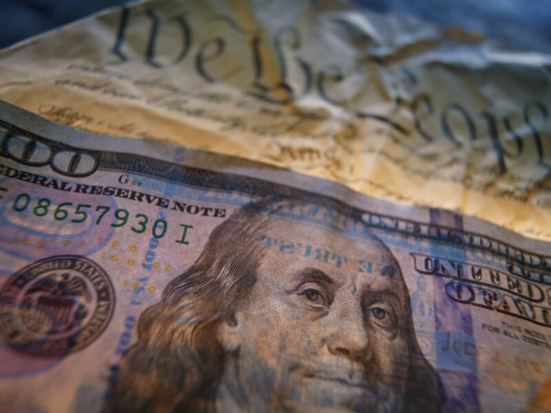 Hundred dollar bill on the US Constitution