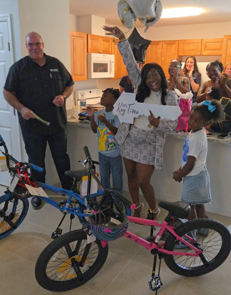 Vanessa Mingo middle celebrates the blessing of her new home in Ocala
