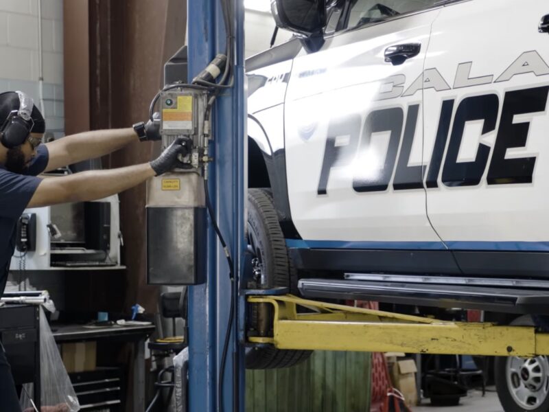 A fleet management technician works on an Ocala Police Department vehicle.