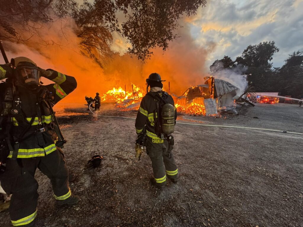 Firefighters survey damage at the Tizwhiz fire on Tuesday