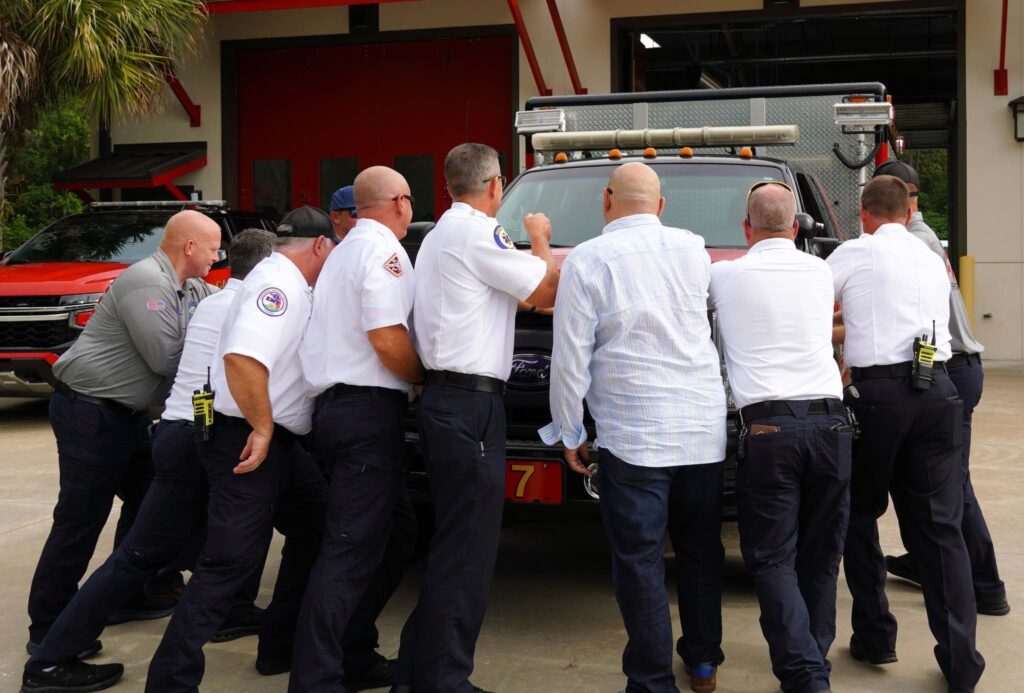 Ocala Fire Rescue personnel and city officials push in the new rescue vehicle at Station 7 in southeast Ocala.