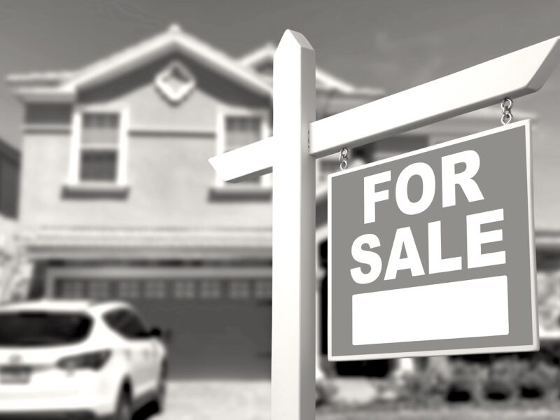 Home For Sale Real Estate Sign and Beautiful New House