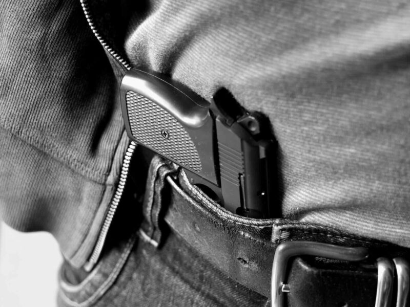 Firearm in holster on waist