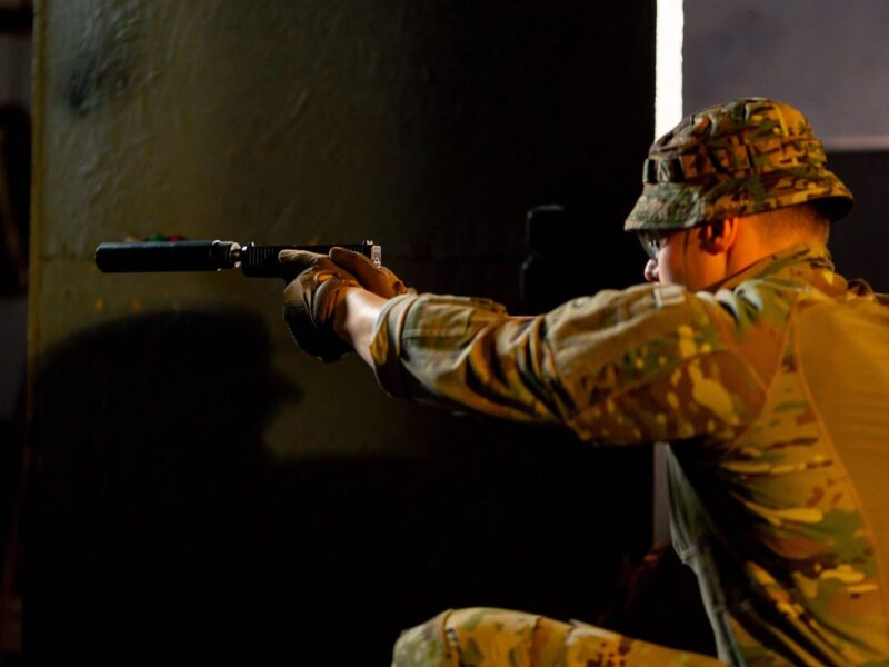 Man with weapon, firearm at simulated munitions facility