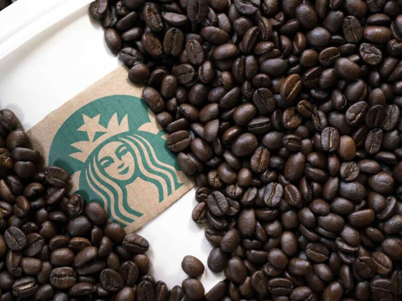 Starbucks cup in coffee beans