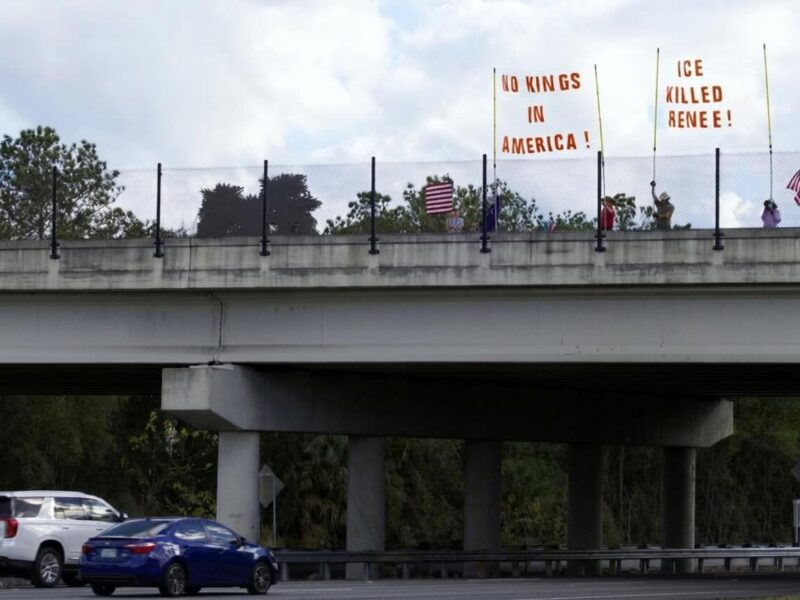 Protestors holding anti ICE signs above Interstate 75 in Ocala