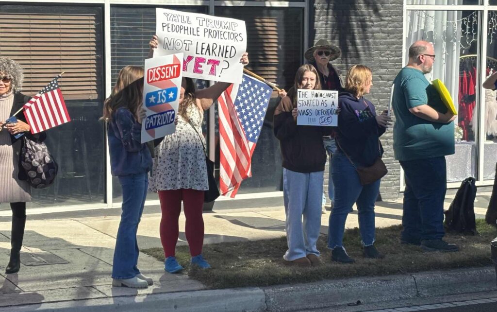 Protestors on the side of a road in Ocala