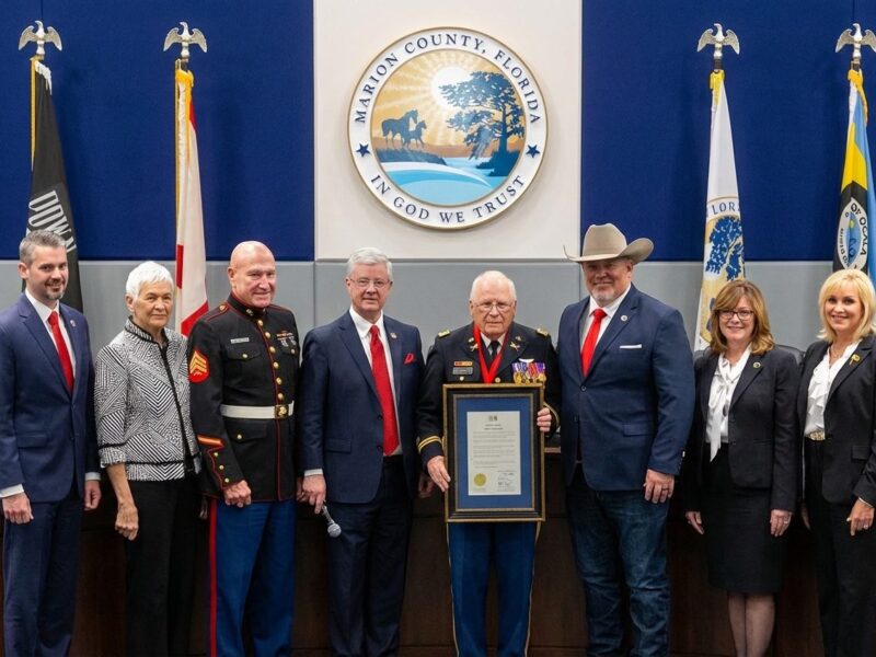 Steve Petty middle accepts the proclamation for the day honoring him and recognizing his induction into the Florida Veterans Hall of Fame.