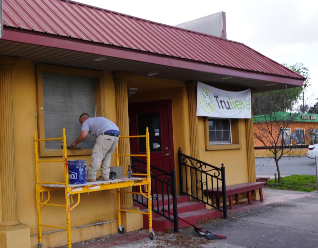 A worker outside of the new Trulieve that is replacing the former Belleview Pizza and Italian Restaurant