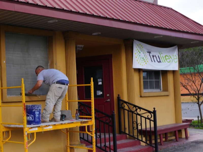 A worker outside of the new Trulieve that is replacing the former Belleview Pizza and Italian Restaurant