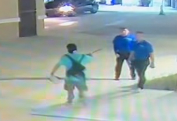 Bryce James Thayer pointing an axe at the two Ocala car wash employees. photo MCSO