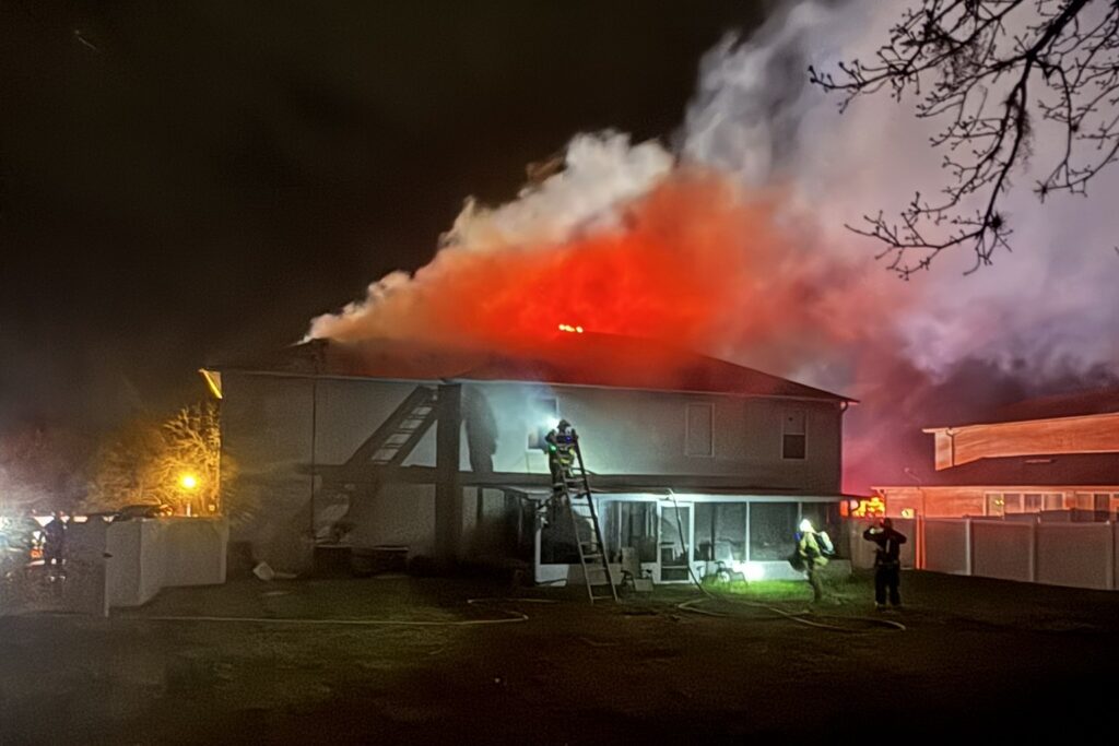 Smoke billowing from the home that caught fire from a lightning strike