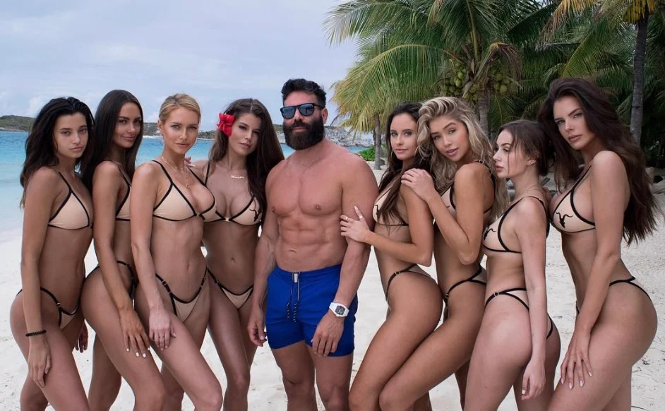 Dan Bilzerian middle surrounded by models