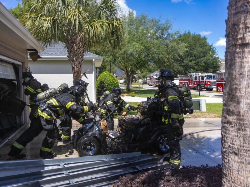 The golf cart that caught fire in the garage was pulled out by firefighters