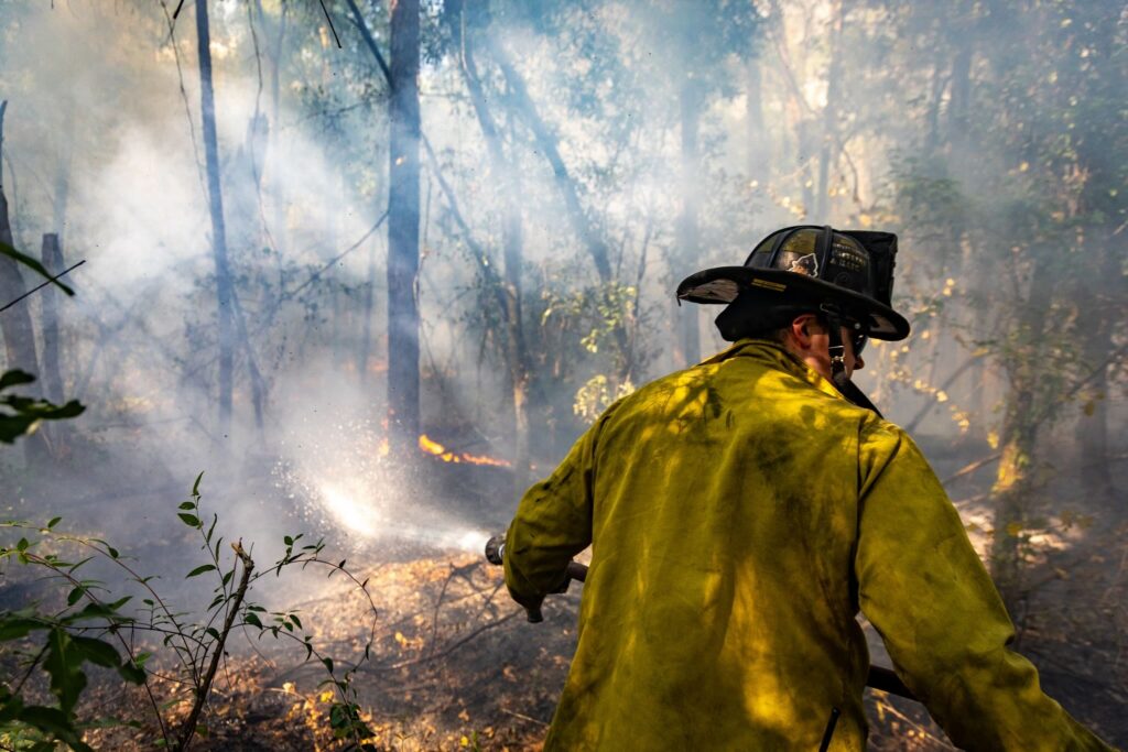 Another MCFR firefighter douses the fire with water