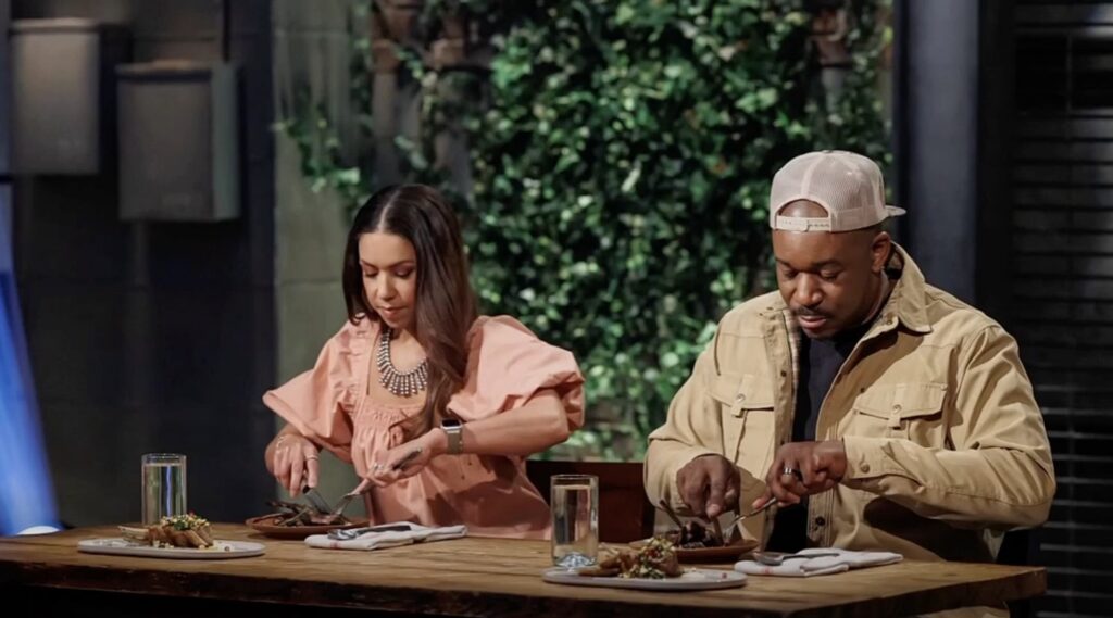 Rashad Jones right tries food during Beat Bobby Flay