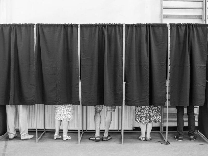 Voters in voting booths casting their votes