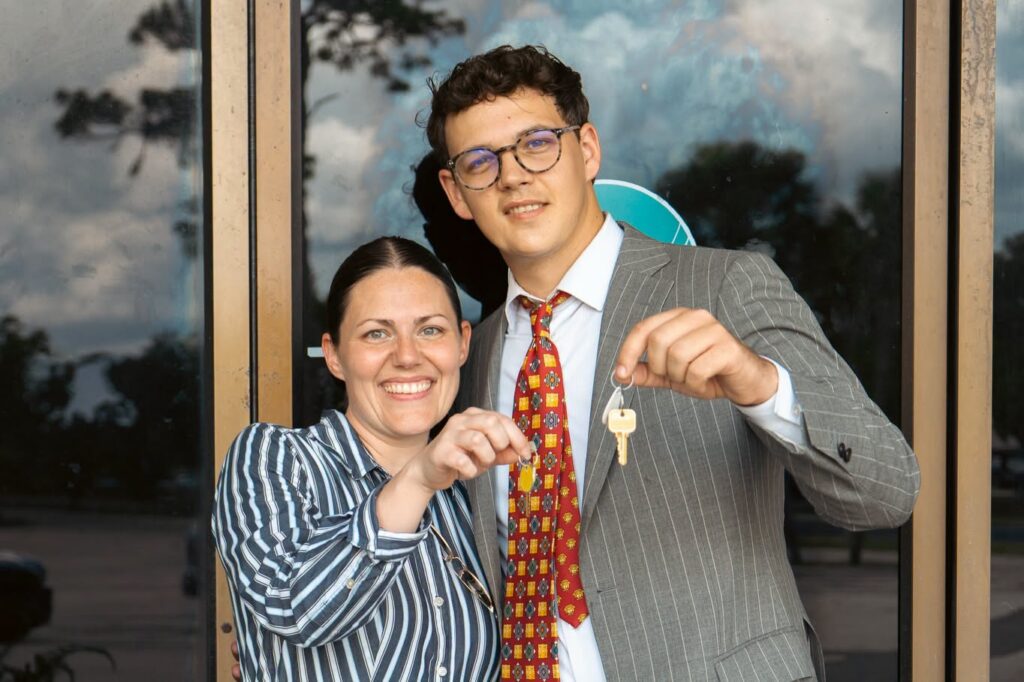 Ryan Brister right and his wife, Megan, as they hold the keys to their new location