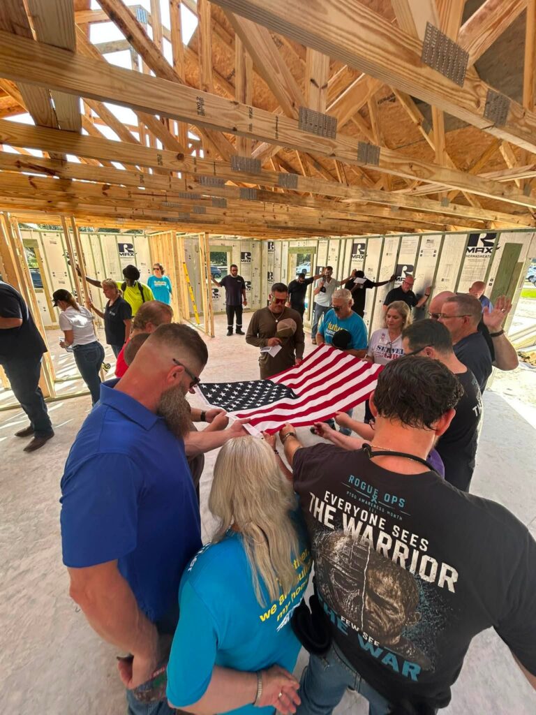 The Haynes family and others pray for the home