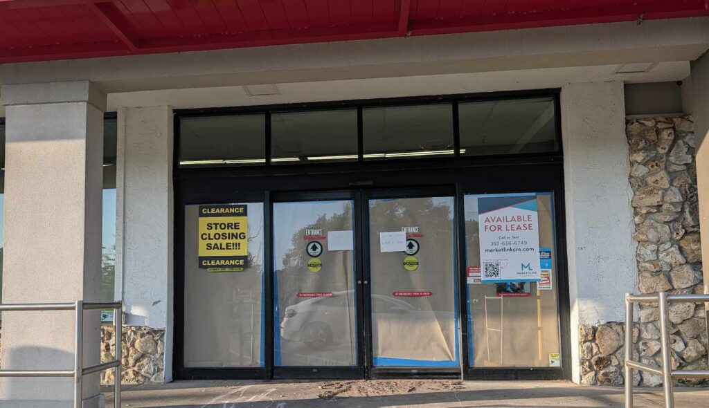 A "Store Closing Sale!!!" sign and several other signs adorn the shuttered Winn-Dixie in Silver Springs.